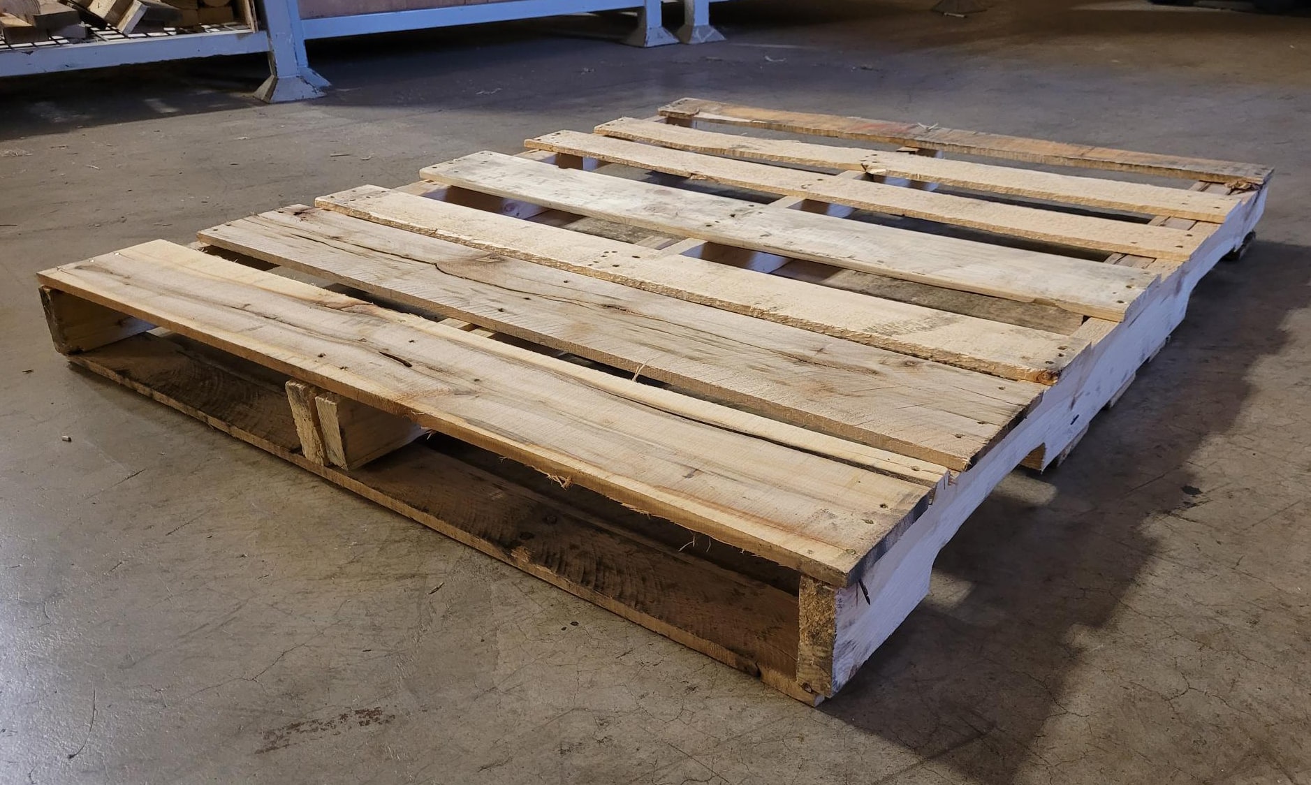 Economical and functional Grade B recycled wooden pallet, suitable for lighter loads and budget-conscious logistics requirements.